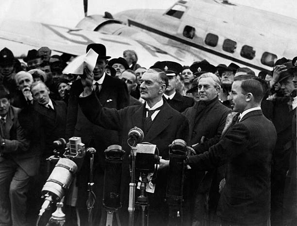 Neville Chamberlain at Heston Aerodrome on his return from Munich after meeting with Hitler in September 1938